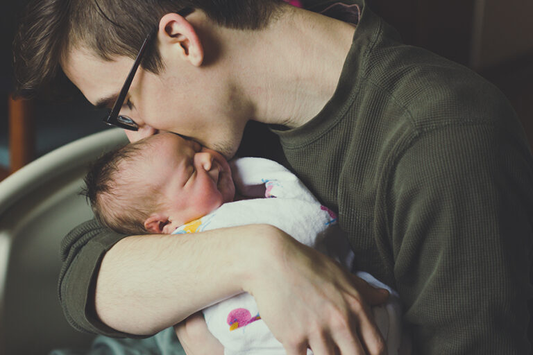 close-up-man-kissing-newborn-baby